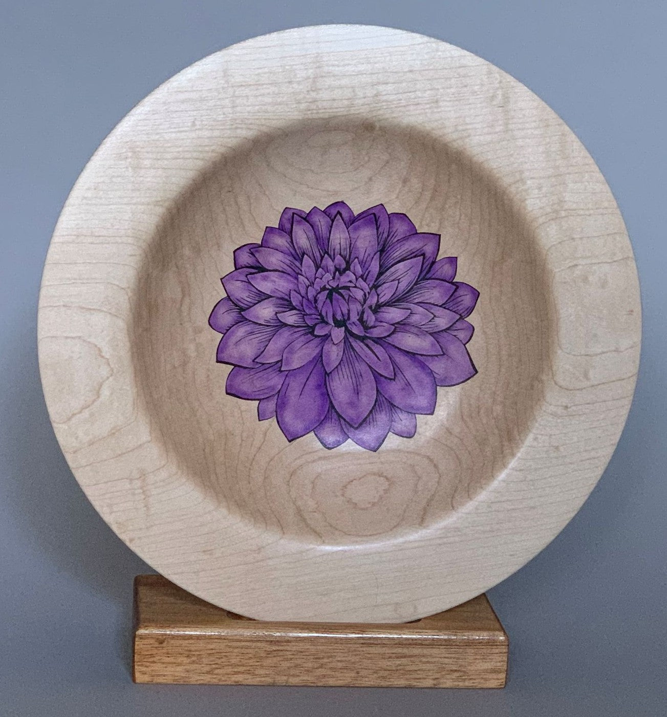 Purple flower on a maple platter